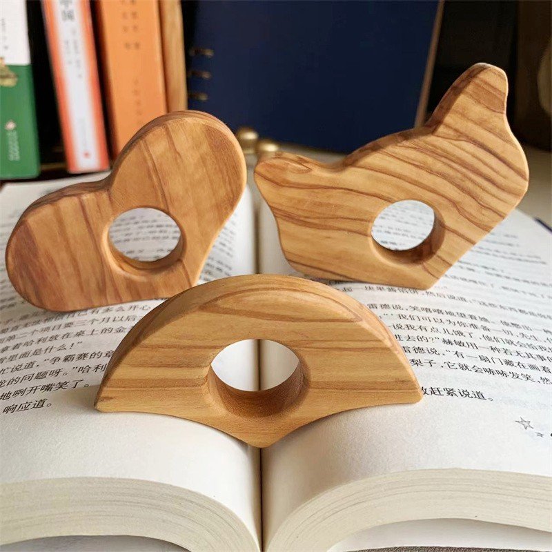 Olive wood page holder ring in heart, bird, and arch shapes